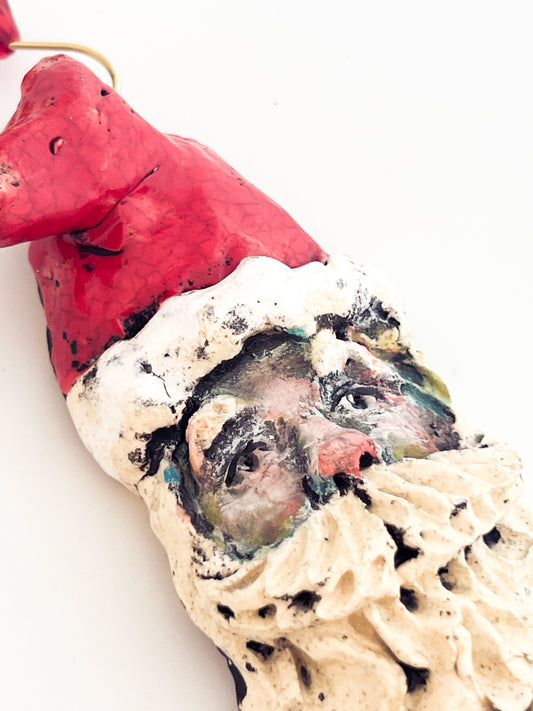 Artistic depiction of a face on a textured surface with a red element