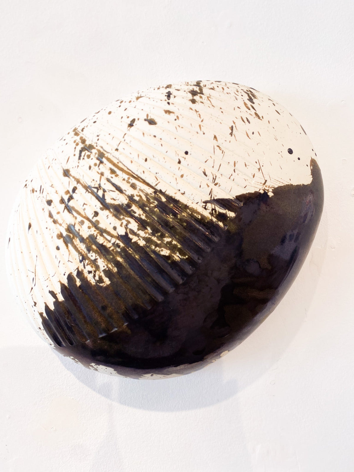 Decorative glass sphere with black and white pattern on a white background