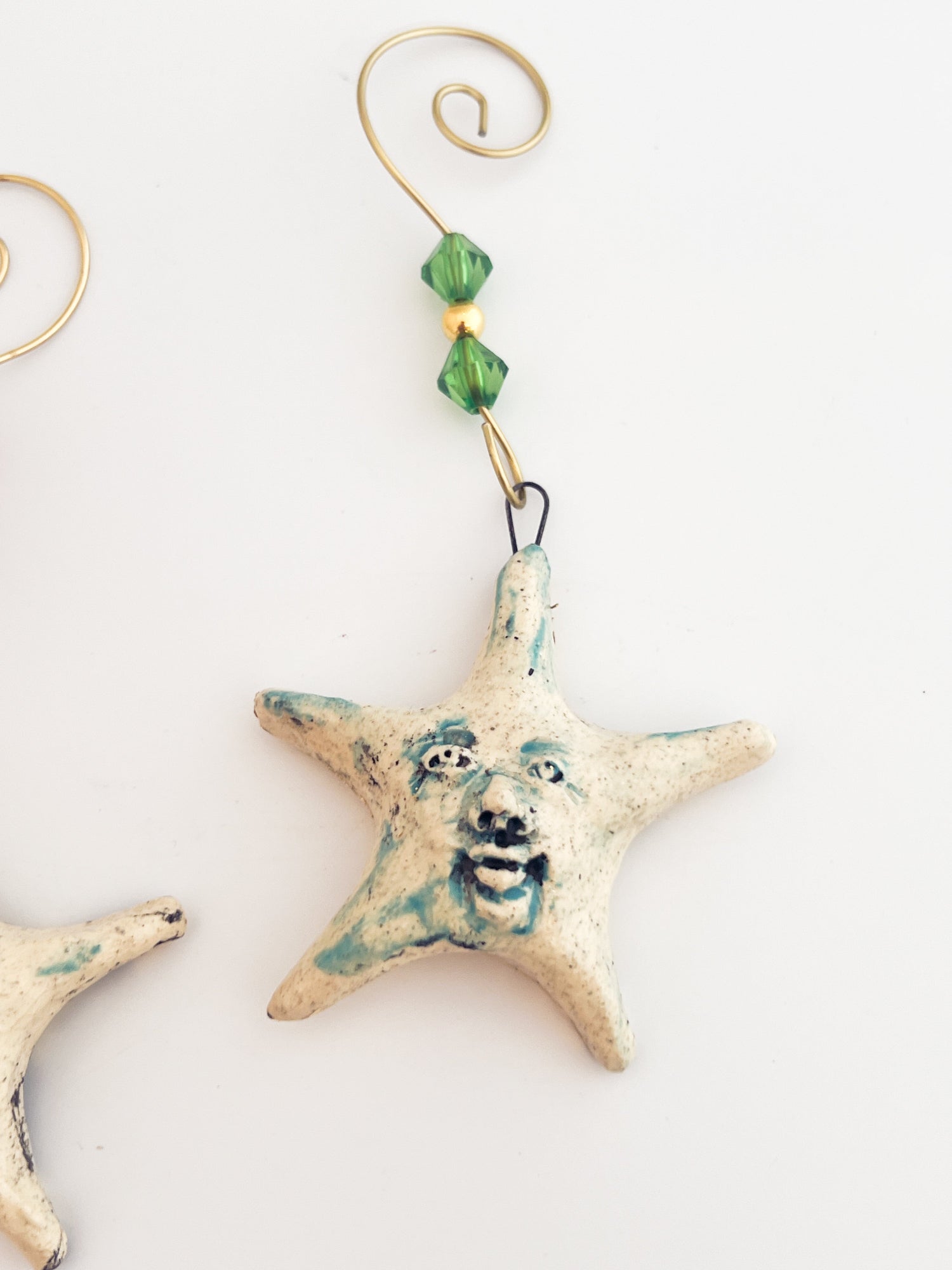 Decorative starfish ornament with a face on a white background